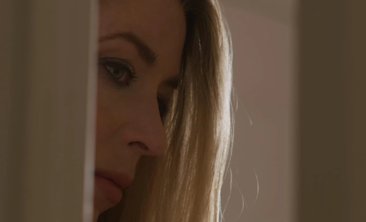 A woman looks around a corner in Demise now out from Maracle Media