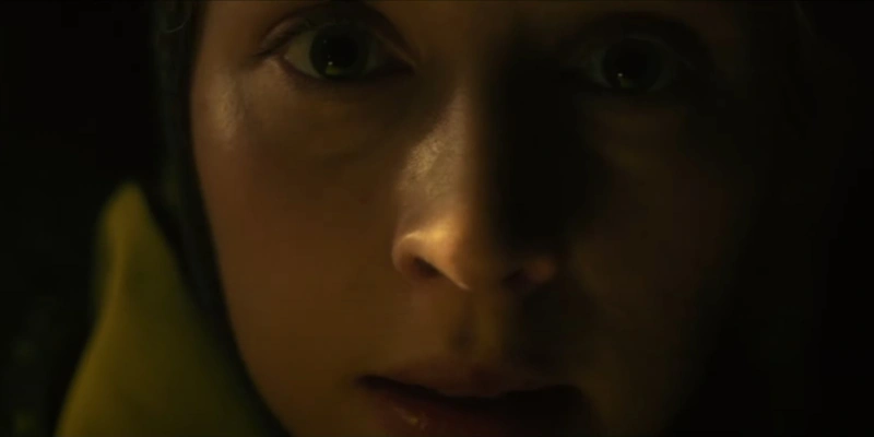 A scared woman looks on in Fear Below