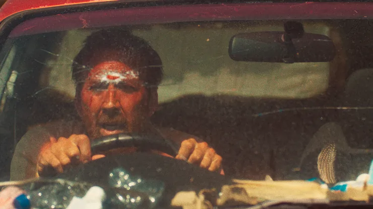 Nicolas Cage drives a bullet ridden car in The Surfer