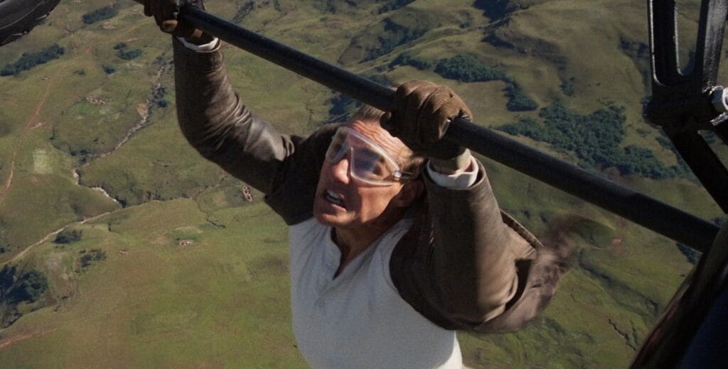A man hangs off a plane - Tom Cruise