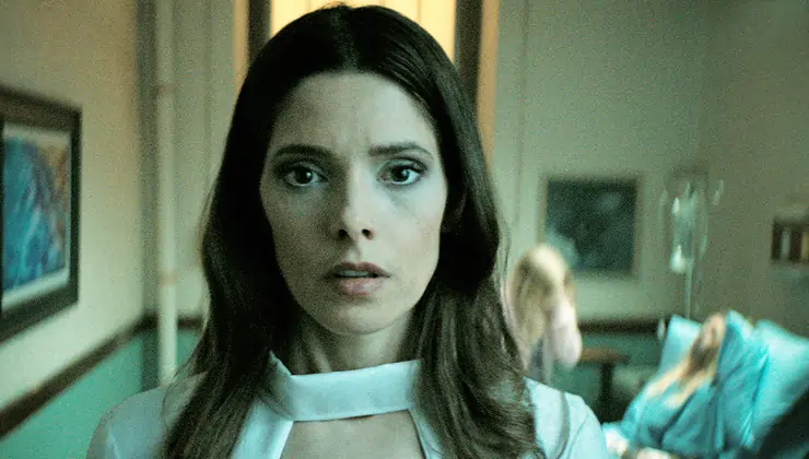 A woman looks on in fear in It Feeds (starring Ashley Greene)