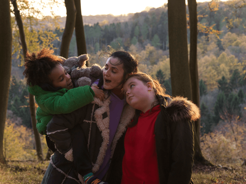 A mother and her children embrace in Lollipop