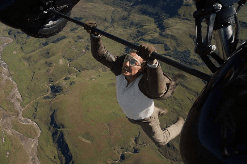 A man dangles off a aircraft mid air in Mission: Impossible - The Final Reckoning