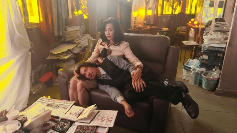 A man and a woman share a sofa