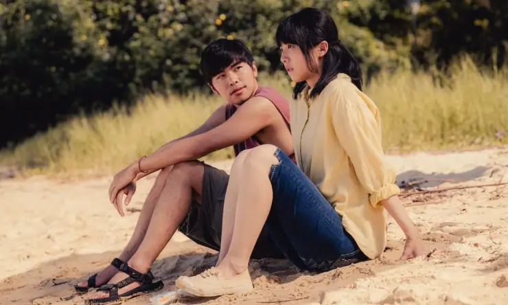 A man and woman talk on the beach in The Way We Talk