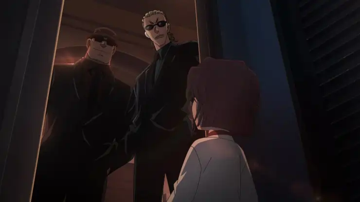 2 men in black talk to a young girl in Detective Conan