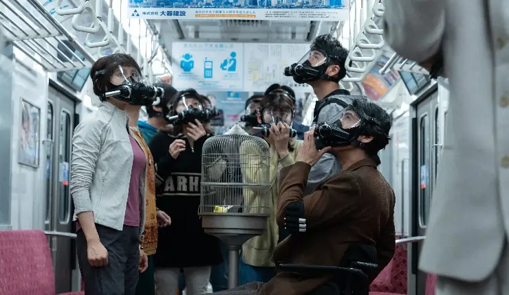 A group of people masked stand together on a train in Alice In Borderland Season 3