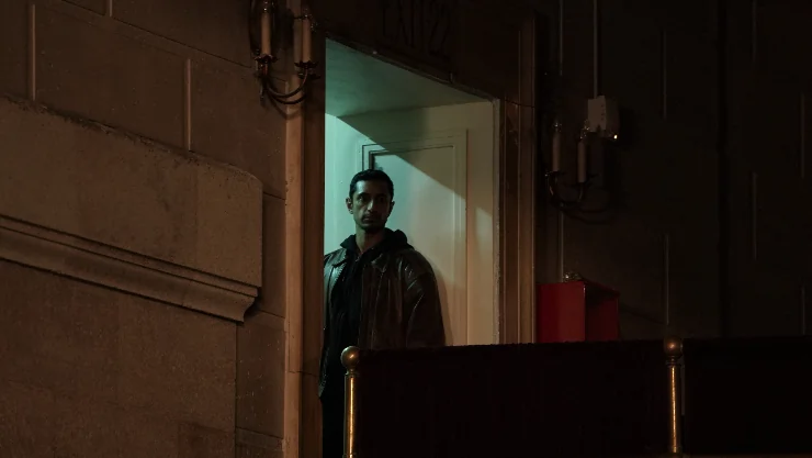 Riz Ahmed hides in the dark in Relay