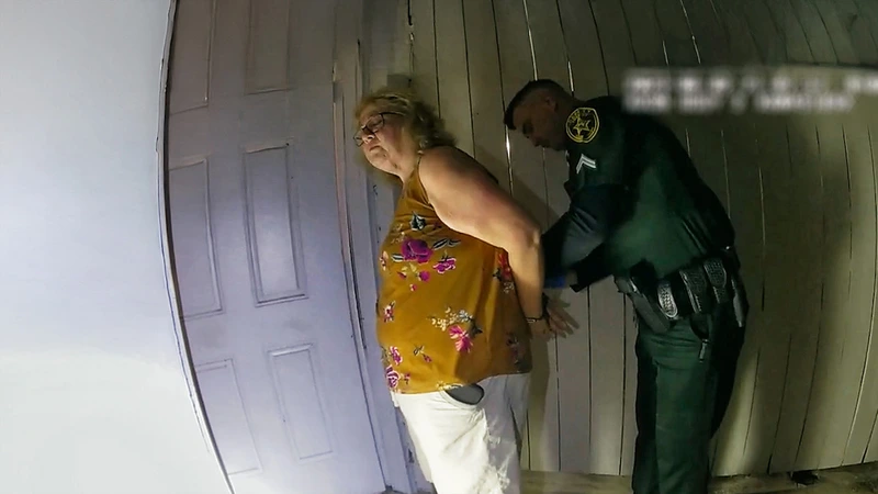 A middle aged woman getting arrested in The Perfect Neighbour.