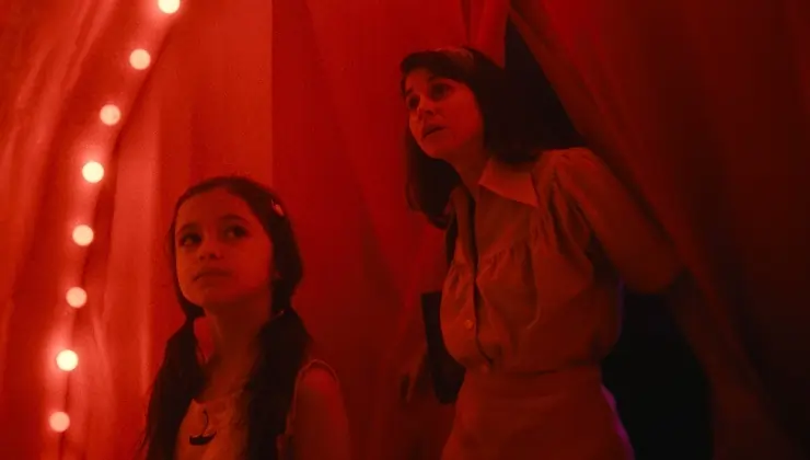 A woman and young daughter enter a fun house in A Mother's Embrace
