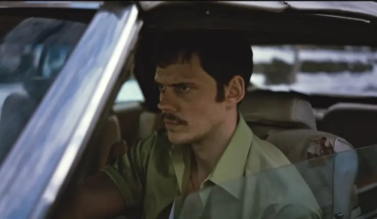 An angry man drives a car possibly in 1970's in Dead Man's Wire