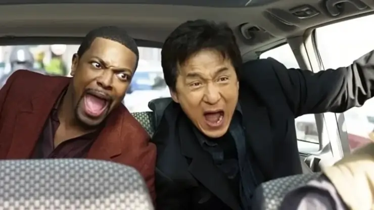 A black man and Asian man screaming in back of car