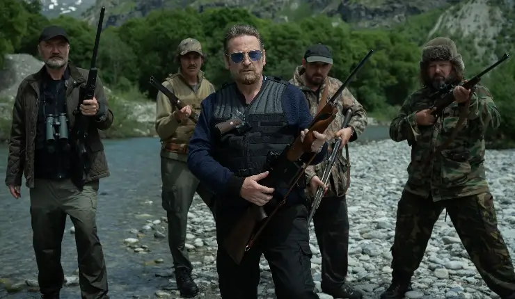 A group of men ready t hunt next to riverside