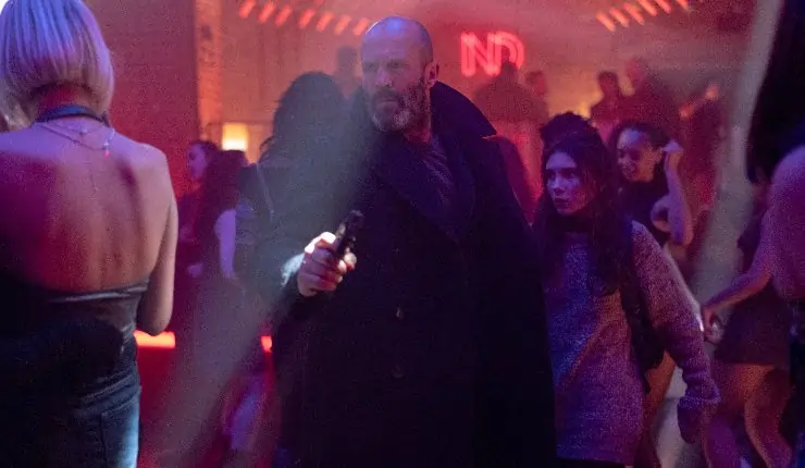 An older bearded man guides a young girl to safety in a club a scene from Shelter.