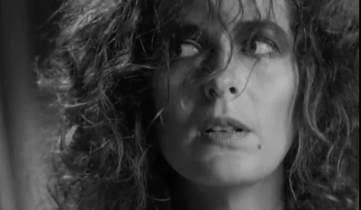 A brunette woman with frazzled hair in 1990 film Singapore sling