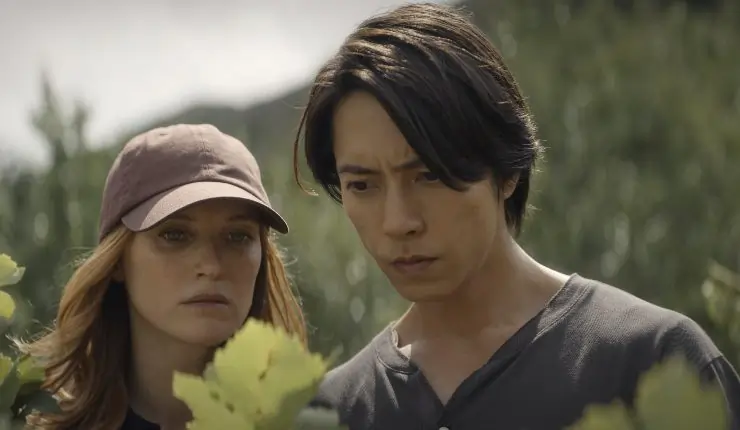 A man and woman look at the grapes for wine in Drops Of God Season 2.