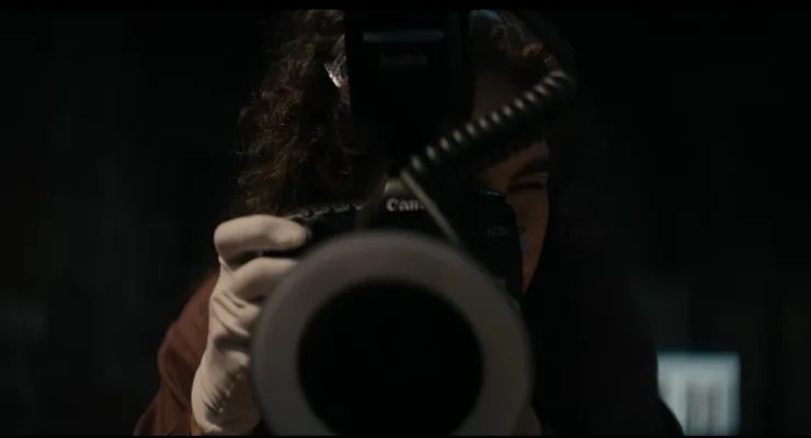 A woman on a crime scene taking photograph's in Lee Cronin's The Mummy.