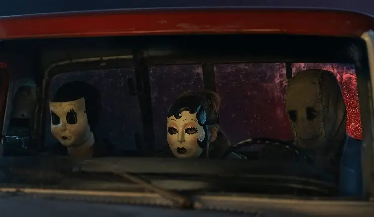 3 masked people sit in a car or van watching someone or something in Strangers: Chapter 3.