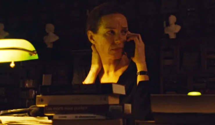 A woman in a dark room is on her phone in Chronovisor