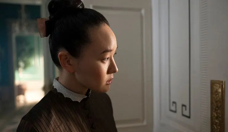 A maid/Woman looks through the peephole in Bridgerton Season 4