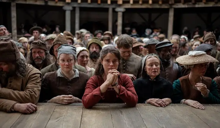 Jessie Buckley in Hamnet in the theatre at the front ready to watch.