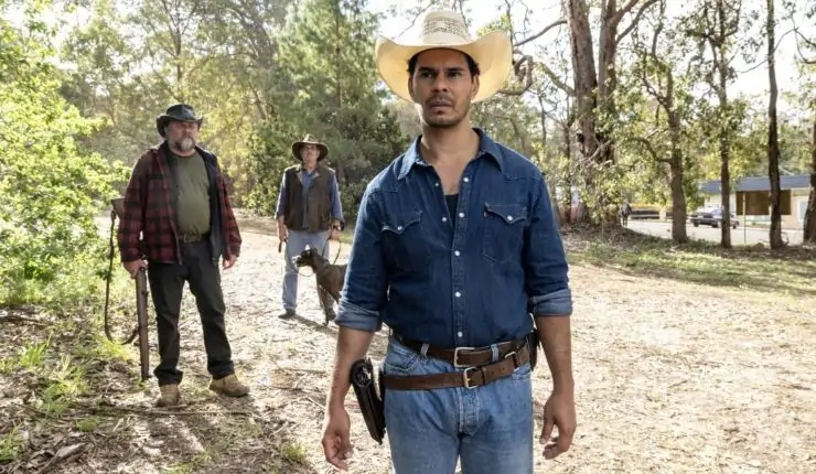 A man in denim and cowboy hat investigates something in Mystery Road Season 2