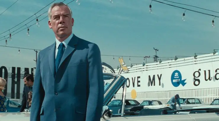 Lee Marvin stands in a car showroom lot in Point Blank (1967)