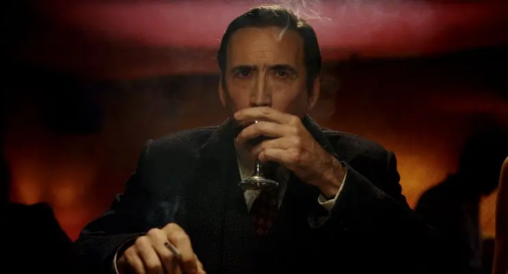 Nicolas Cage in Spider-Noir taking a drink.