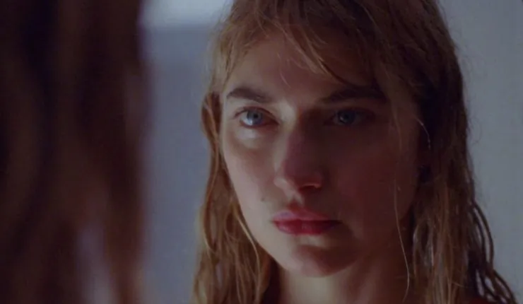 Imogen Poots looks into a mirror after swimming in The Chronology Of Water