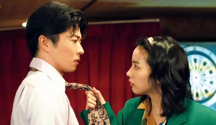 An angry woman grabs a mans tie in The Hotel Of My Dreams