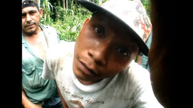 A man in white baseball cap looks straight into the camera in Amazonmania documentary