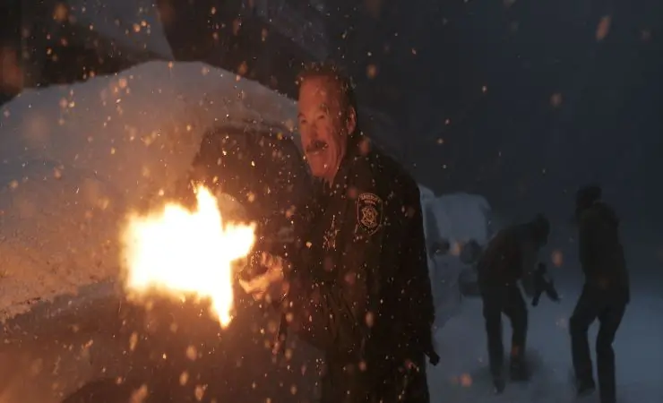 A sheriff firing a machine gun in Normal Review