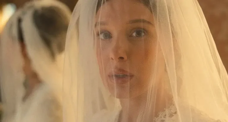 A young woman looks concerned wearing a wedding veil