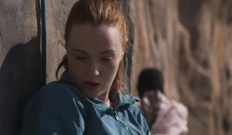 A woman looks down in trepidation as another starts walking (credint Signature Entertainment)