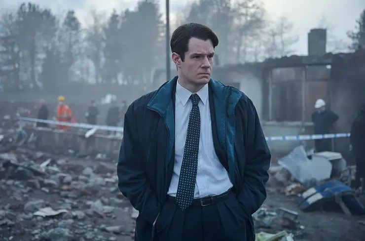 a man looks at the rubble in The Bombing of Pan Am