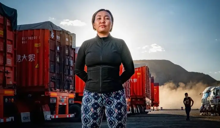 A Mongolian woman in blue stands strong