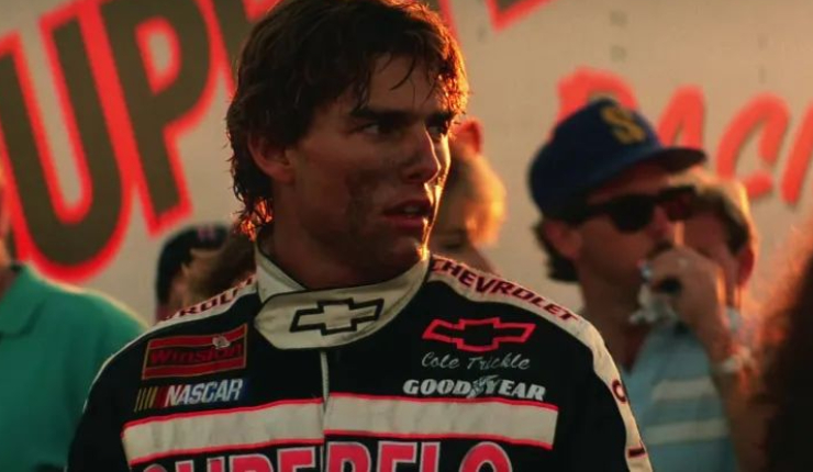 Tom Cruise covered in dirt and sweat after a race.