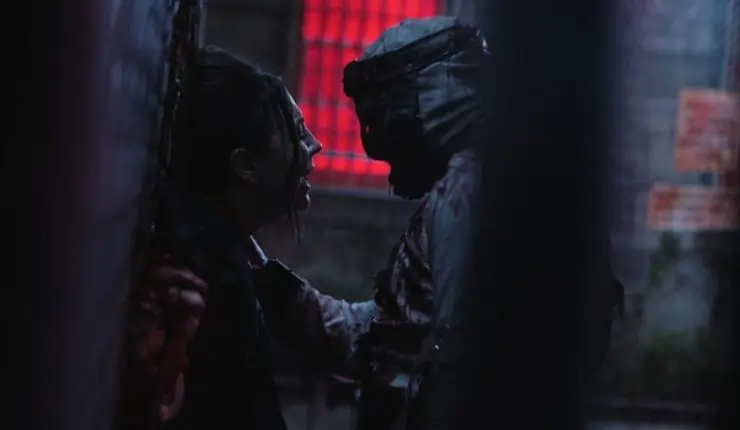 A woman is hed against the wall in Fresh Meat