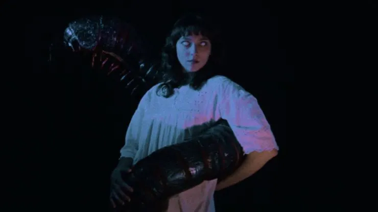 A woman is embraced by a giant centipede