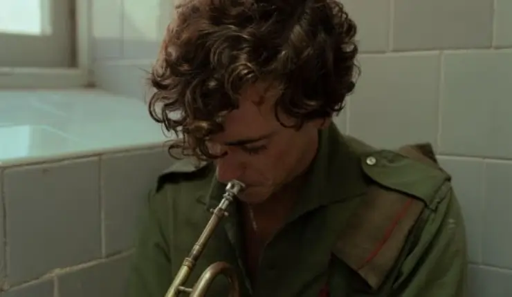 A man sadly playing an instrument