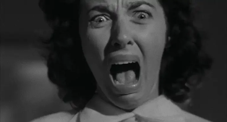 A close up of woman screaming in The Screaming Skull (1958)