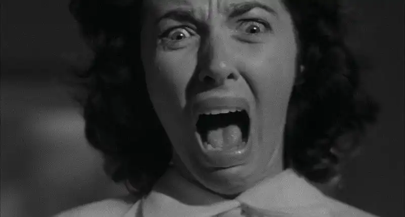 A close up of woman screaming in The Screaming Skull (1958)