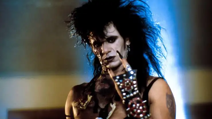 A burnt man in metal music hair metal look in Trick or treat