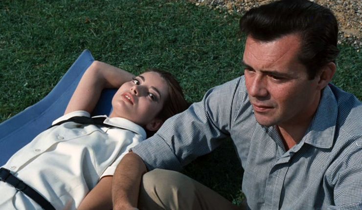 A man in grey shirt sits up next to woman lying down in Accident