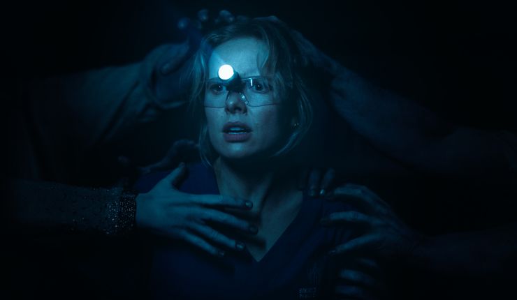 A woman ready to battle the demon in Insidious: Out Of The Further