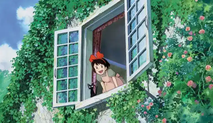 A young animated girl with her black cat hangs out the window in Kiki's Delivery Service.