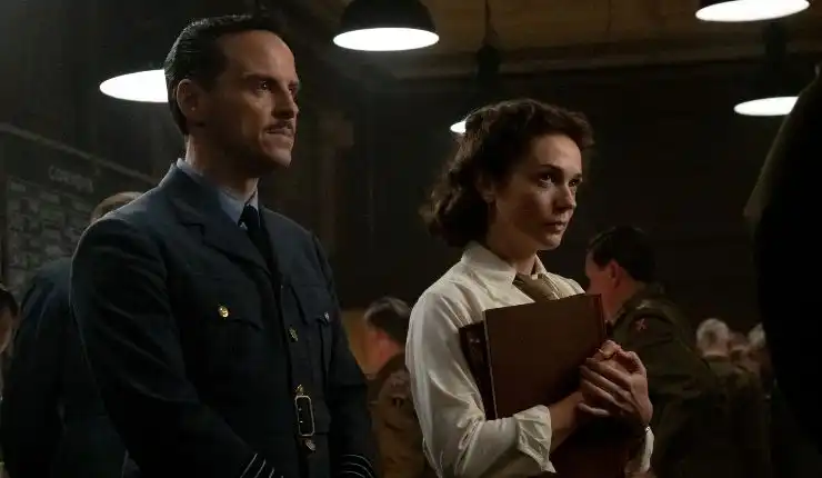 A man and woman look on on something in Pressure, will they win?