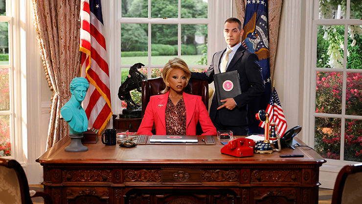 RuPaul as President Judy Gagwell in the Oval Office, with assistant Matt Rogers standing by