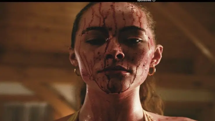 A woman is covered in blood