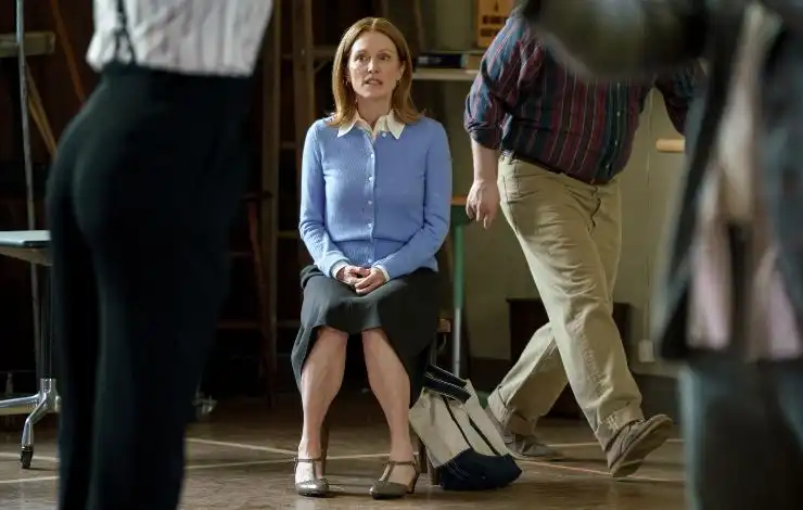 An middle aged woman sits down as people walk around her in The Debut (Courtesy of Lionsgate)